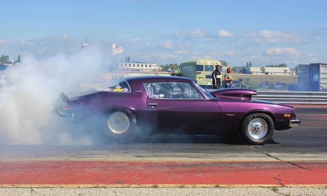 A car speeding down a legal drag strip during an organized race