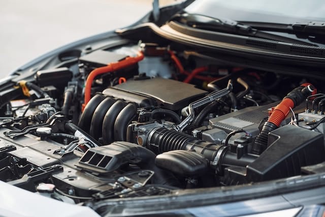 Image of a car engine showcasing various clips and retainers, highlighting the importance of these components in vehicle maintenance. The photo serves as a visual reminder that issues with these parts can sometimes arise after professional repairs, often due to factors like improper installation or natural wear and tear.