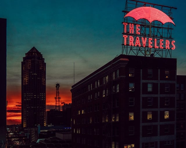 Downtown Des Moines skyline featuring the iconic Travelers umbrella sign, a symbol of the city's vibrant urban landscape.