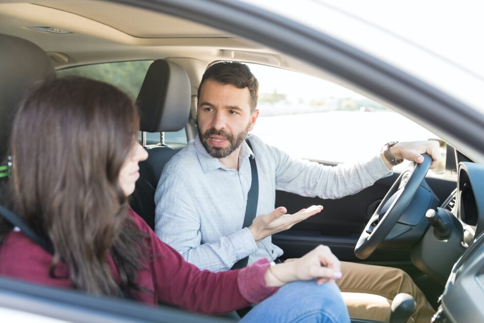 An image portraying the impact of car jerking on daily life and vehicle usability. It shows a frustrated driver behind the wheel of a car that has come to an abrupt stop, symbolizing a malfunction due to jerking. The driver's expression and posture convey the inconvenience and disruption caused by this mechanical issue, emphasizing the potential for car jerking to render a vehicle unreliable for daily use. The background hints at a typical urban setting, suggesting the broader impact of such car troubles on routine activities.