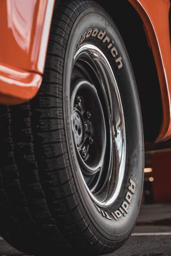 Close-up view of a Goodrich tire mounted on a car, with the fender visibly arching above it, highlighting the tire's brand and the fender's contour