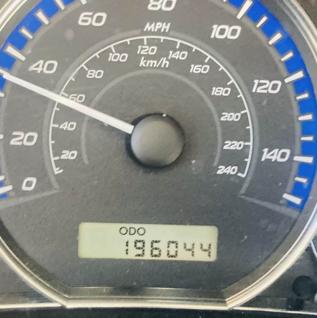 Close-up view of a car odometer displaying 196,044 miles.